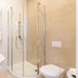 Osrodek Wypoczynkowy Wiga bathroom in Kolobrzeg with glass shower, sink, and toilet