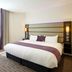 Premier Inn Ashford - Eureka Leisure Park guest room with king bed, window light, and upholstered headboard