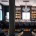 The Wellem Düsseldorf hotel bar with chandelier, backlit shelves and seating
