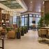 The Leo Kent Hotel, Tucson lobby with lounge seating, bar stools, chandeliers, and floor-to-ceiling windows