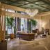 The Leo Kent Hotel, Tucson lobby with chandelier, leather seating and tall potted plants