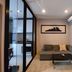 Many Holiday The Base Condo Pattaya living area with sofa, coffee table and kitchen view