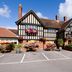 Premier Inn Christchurch - East exterior in Christchurch, a Tudor-style hotel with flower baskets and parking