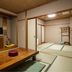 Hotel Ikedaya in Matsumoto: traditional tatami room with low table and TV