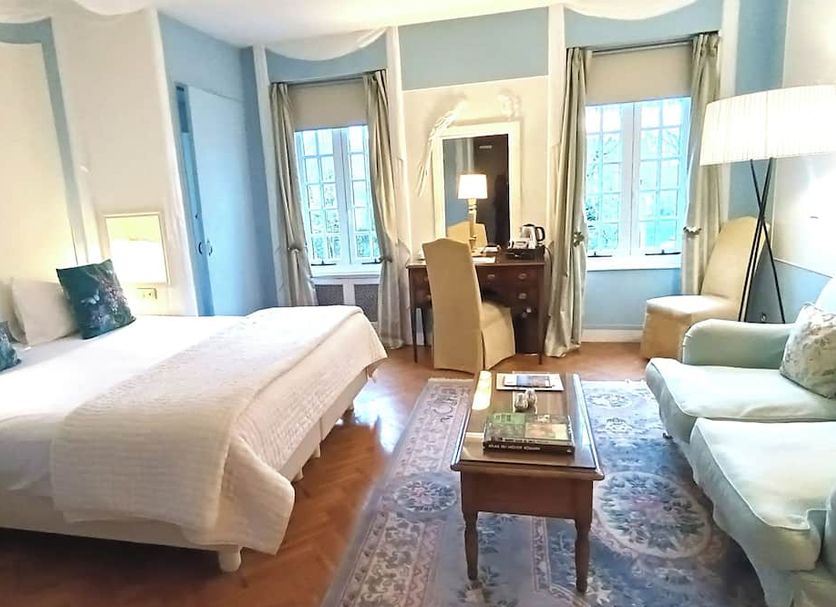Chateau De Montreuil guest room in Montreuil with king bed, desk, sofa, and two windows