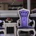 White Fort Hotel in Dubai lobby seating with two purple upholstered chairs and small table