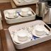Ritumbhara Resorts Alwar tea tray with white cups and stainless steel kettles on a wooden table