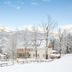 Hotel Jufa Grundlsee in Gössl with a snowy mountain view and winter landscape beside the hotel