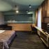 Ibis Styles Riga guest room with bed, sofa, desk, and city-themed wall art