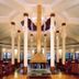 Ananda in the Himalayas lobby with tall columns, central fireplace and lounge seating in Rishikesh