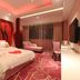 Longwan Hotel (Foshan Ceramics City) room in Foshan with red rose mural, bed, chaise lounge, and patterned carpet