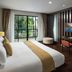 Centara Anda Dhevi Resort & Spa Krabi room with balcony view, bed, desk, and TV in Ao Nang