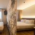 Logis Hôtel de Port d'Alon room with two beds, tropical mural wall and window in Saint-Cyr-sur-Mer