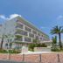 La'gent Hotel Okinawa Chatan in Chatan with palm trees and a modern white exterior