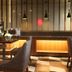 Aventree Hotel Busan lobby seating area with tables, chairs, and warm backlit bar counter