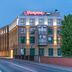 Hampton by Hilton Oswiecim hotel exterior in Oświęcim at dusk with illuminated signage