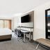 Holiday Inn Express Atlanta Galleria-Ballpark Area in Smyrna guest room with king bed, desk and wall-mounted TV