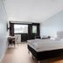 Aiden by Best Western Haugesund Airport room in Avaldsnes with king bed, desk and balcony door