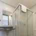 Paulista Garden Hotel Sao Paulo bathroom with glass-enclosed shower, sink and toilet