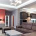 City Park Hotel Chisinau suite living room with sofa, coffee table, accent wall, and modern lighting
