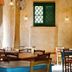 Agriturismo Cerrolungo in La Spezia dining room with rustic tables, chairs and hanging lights
