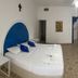 Hotel Paraiso Kora room in San Blas with a bed, tiled floor, and open kitchenette area