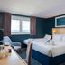 Travelodge London Kingston Upon Thames guest room with twin beds, desk, and a window view