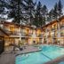 Firelite Lodge in Tahoe Vista with outdoor pool, balcony rooms, and pine trees at dusk