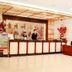 Nan Xiang Hotel - Guiyang lobby front desk with staff and floral arrangements