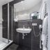 Schieners Hotel & Apfelhof Apartments in Wemding bathroom with walk-in shower and wall-mounted sink