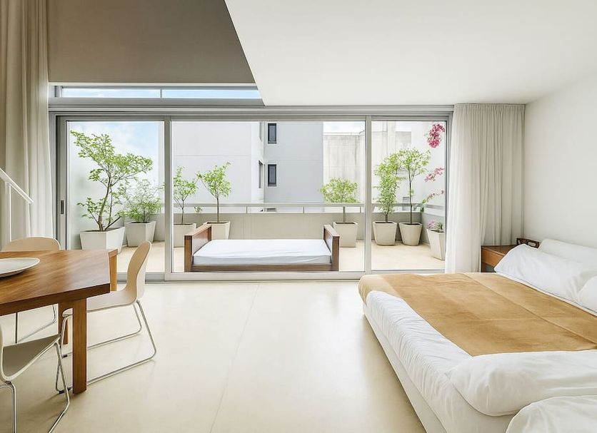 cE Design Hotel Buenos Aires room with balcony, large glass doors, and minimalist white bedding
