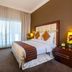 Flora Park Deluxe Hotel Apartments in Dubai guest room with king bed and floor-to-ceiling window