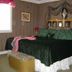 The Garden Walk Bed & Breakfast bedroom in Lookout Mountain with ornate bed and draped window treatments