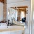 La Freixera in Solsona bathroom with freestanding tub, large mirror, and exposed brick detail