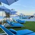 Eurostars Ibiza in Ibiza: blue loungers by the pool terrace overlooking the sea at sunset
