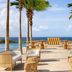 Secrets Baby Beach Aruba Adults Only in Sint Nicolaas: oceanfront terrace with lounge chairs, tables and palm trees