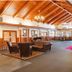 Hanah Mountain Resort And Country Club lobby in Margaretville with wood beams, seating area and front desk