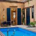Dona Elvira Boutique Hotel in Santo Domingo with courtyard pool, blue doors and arched passage