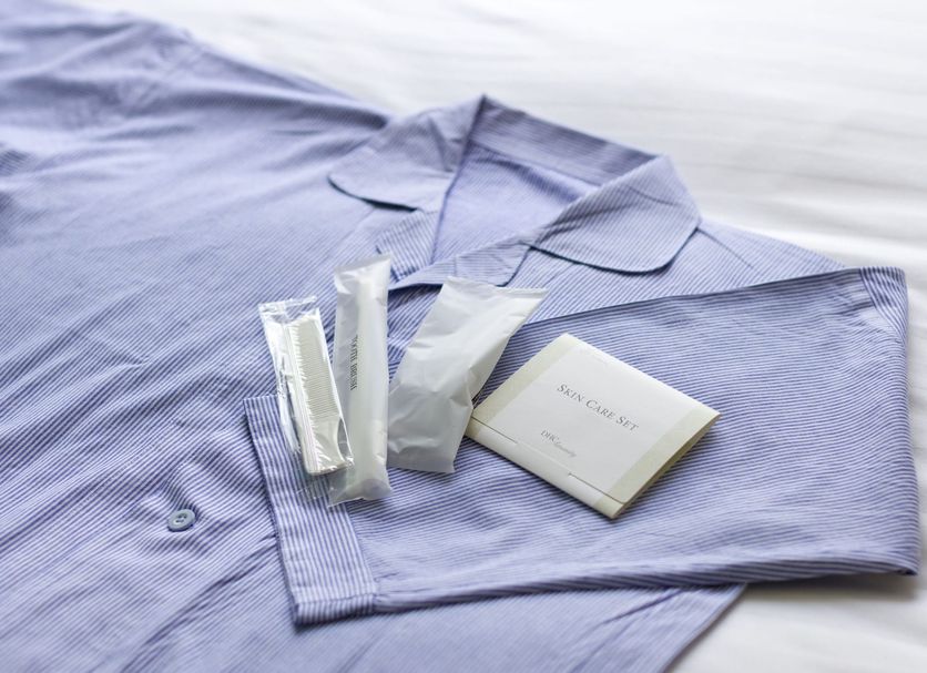 Toyoko Inn Toyohashi eki Higashi guchi robe with toiletries laid out on a bed in Toyohashi