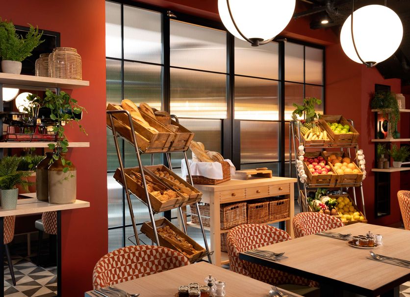 Hyatt Place London City East breakfast area with pastry display and red walls in London