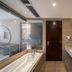Aimoer Hotel Foshan bathroom with soaking tub, double sink vanity, and glass shower partition