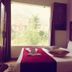 Hotel Vishla Palace, Rishikesh guest room with large window, bed, and tufted headboard