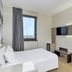B&B Hotel Milano-Monza guest room in Monza with bed, wall-mounted TV, desk and window