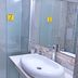 Rohat Hotel Dushanbe bathroom with glass shower, vessel sink, and mirror