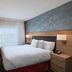 TownePlace Suites by Marriott Naples guest room with king bed, desk, and window with sheer curtains