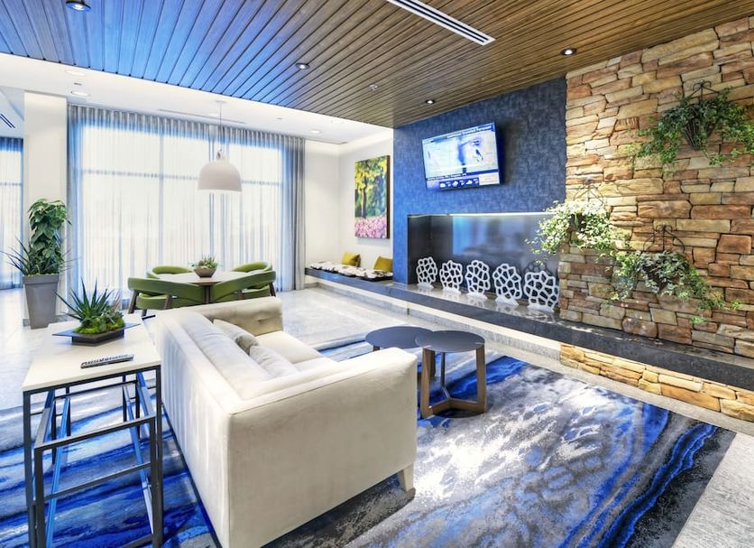 Fairfield Inn & Suites by Marriott Ottawa Airport lobby with stone fireplace, sofa seating and TV in Ottawa