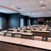 Meeting room at SpringHill Suites by Marriott Navarre Oceanfront in Navarre with rows of tables and chairs
