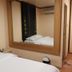 Suriwongse Hotel Bangkok guest room with twin beds, mirror wall, and air conditioner