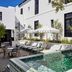 Cape Cadogan Boutique Hotel in Cape Town courtyard pool with lounge chairs and white umbrellas