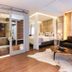Hotel Cercano Gramado suite with four-poster bed, soaking tub, leather sofa and large window